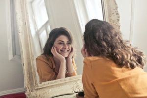 woman smiling in mirror